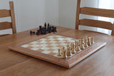 Image of a Koi Chess Board Set on dining table with chairs
