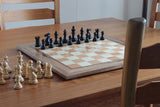 Image of a Gecko Chessboard on a table with chairs
