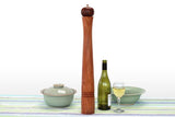 Giant Orb Blackwood Pepper Mill on a table with a wine bottle