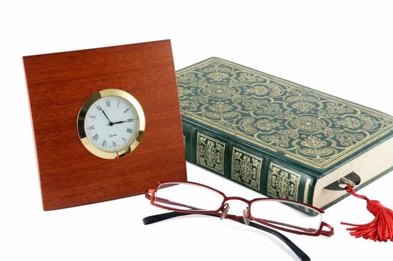Image of a Square Jarrah Desk Clock with glasses and book